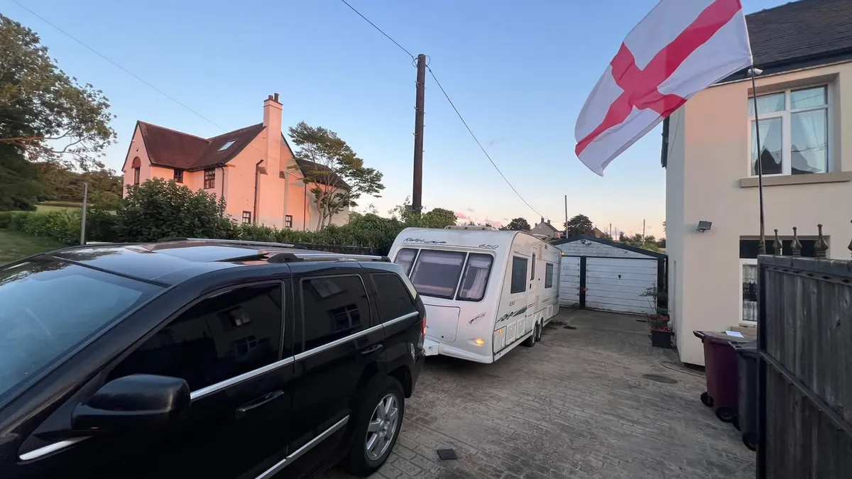 Touring caravan on a driveway at sunset, ready to be sold