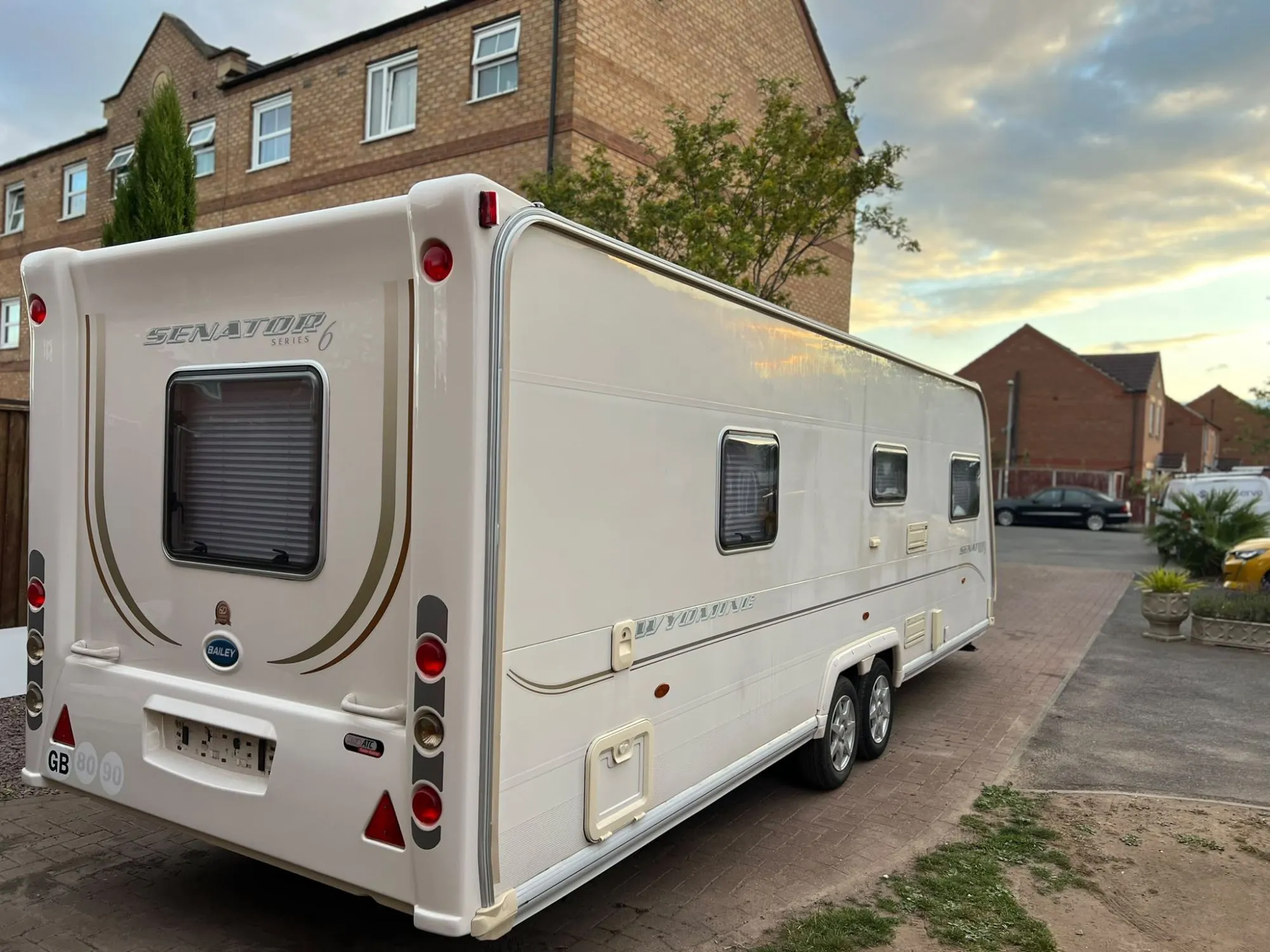 Bailey Senator twin-axle touring caravan on a driveway at sunset